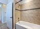 Bathroom with neutral tile shower and tub combination at 2588 Egret Loop, Kissimmee, FL 34743