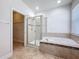 Bathroom featuring shower, garden tub, and tile flooring at 2588 Egret Loop, Kissimmee, FL 34743