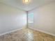 Neutral bedroom with tile flooring and a window at 2588 Egret Loop, Kissimmee, FL 34743