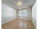 This bedroom features natural light, a neutral paint color, and tile flooring throughout at 2588 Egret Loop, Kissimmee, FL 34743