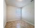 Empty bedroom featuring tile flooring, blinds, and neutral paint at 2588 Egret Loop, Kissimmee, FL 34743