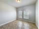 Bright, empty bedroom featuring tile flooring and two windows at 2588 Egret Loop, Kissimmee, FL 34743