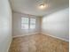 This bedroom features neutral paint, tile flooring, and natural light from the large windows at 2588 Egret Loop, Kissimmee, FL 34743