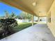 The covered patio looks out onto the grass and fenced yard with a view of the neighborhood at 2588 Egret Loop, Kissimmee, FL 34743