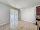 Open dining area featuring tile flooring and a sliding glass door leading to outdoor space at 2588 Egret Loop, Kissimmee, FL 34743