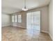 Sunlit dining area with tile flooring, a glass sliding door to the patio, and views of the backyard at 2588 Egret Loop, Kissimmee, FL 34743