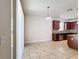 Bright dining space featuring tile flooring and views of the modern kitchen with stainless appliances at 2588 Egret Loop, Kissimmee, FL 34743