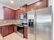 This kitchen has granite counters, stainless steel appliances, and wooden cabinets at 2588 Egret Loop, Kissimmee, FL 34743