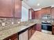 Well-equipped kitchen with stainless steel appliances, tile backsplash, and granite countertops at 2588 Egret Loop, Kissimmee, FL 34743