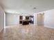 Spacious living room featuring tile flooring, with an open view into the modern kitchen at 2588 Egret Loop, Kissimmee, FL 34743