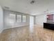 Open-concept living area with tile flooring, ample natural light, and a view of the kitchen at 2588 Egret Loop, Kissimmee, FL 34743