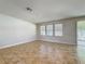 Bright living room with tile flooring, large windows, and a sliding glass door leading to the backyard at 2588 Egret Loop, Kissimmee, FL 34743