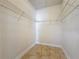 Spacious walk-in closet featuring neutral paint, tile floor, and wire shelving for maximum storage at 2588 Egret Loop, Kissimmee, FL 34743