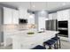 Modern kitchen boasts white cabinets, stainless steel appliances, quartz countertops, and backsplash at 5043 Bear Lake Loop, Deland, FL 32724