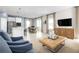 Open concept living space features a modern kitchen, dining area, and cozy seating around a TV at 5043 Bear Lake Loop, Deland, FL 32724