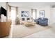 Cozy living room with comfortable seating, neutral decor, and large windows for natural light at 5043 Bear Lake Loop, Deland, FL 32724