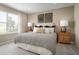 Bedroom featuring a decorative headboard, neutral colors, and bright natural light from window at 5047 Bear Lake Loop, Deland, FL 32724