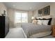 Bedroom featuring a decorative headboard, neutral colors, and bright natural light at 5047 Bear Lake Loop, Deland, FL 32724