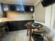 Kitchen nook with dark cabinetry and a small dining table at 629 Copeland Dr, Haines City, FL 33844