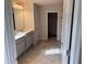 Light-filled bathroom with double vanity and view of additional bath area at 260 Crossings Ave, St Cloud, FL 34771