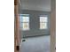Bright bedroom with carpet and two windows at 260 Crossings Ave, St Cloud, FL 34771