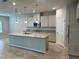 Island kitchen with granite countertops and stainless steel appliances at 260 Crossings Ave, St Cloud, FL 34771