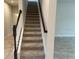 Staircase with carpeted steps and wooden railing at 260 Crossings Ave, St Cloud, FL 34771