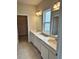 Double vanity bathroom with white cabinets and quartz countertops at 380 Crossings Ave, St Cloud, FL 34771