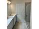 Bathroom with a walk-in shower and a single vanity with quartz countertop at 380 Crossings Ave, St Cloud, FL 34771