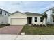 Attractive single-story home with a brick paved driveway and well-manicured lawn at 380 Crossings Ave, St Cloud, FL 34771
