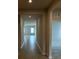 Bright hallway with neutral tile flooring leading to other rooms at 380 Crossings Ave, St Cloud, FL 34771
