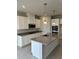 Modern kitchen with island, granite countertops, and stainless steel appliances at 380 Crossings Ave, St Cloud, FL 34771