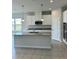 Modern kitchen featuring white cabinets, granite countertops, and stainless steel appliances at 380 Crossings Ave, St Cloud, FL 34771