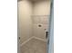 Bright laundry room with built-in shelving and tile floor at 380 Crossings Ave, St Cloud, FL 34771