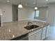 Spacious kitchen with a large island, granite countertops, and stainless steel appliances at 500 Crossings Ave, St Cloud, FL 34771