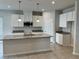 Modern kitchen boasts granite countertops, white cabinets, and a large island at 500 Crossings Ave, St Cloud, FL 34771