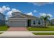 Charming single-Gathering home features a two-car garage, landscaped yard and a well-manicured lawn at 500 Crossings Ave, St Cloud, FL 34771