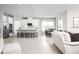 Bright open floorplan featuring a kitchen with stainless steel appliances, quartz countertops, and tile flooring at 500 Crossings Ave, St Cloud, FL 34771