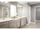 Double vanity bathroom with a large mirror and adjacent walk-in closet at 5781 Anders Way, Saint Cloud, FL 34771