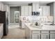 Modern kitchen with white cabinets, quartz countertops, and island at 5781 Anders Way, Saint Cloud, FL 34771