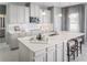 Modern kitchen with white cabinets, quartz countertops, and island at 5781 Anders Way, Saint Cloud, FL 34771