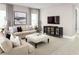 Living room featuring beige sofas, ottoman, and a mounted TV at 5781 Anders Way, Saint Cloud, FL 34771