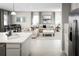 Open living room and kitchen with an island and stainless steel appliances at 5781 Anders Way, Saint Cloud, FL 34771
