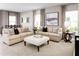 Spacious living room with beige sofas, ottoman, and large artwork at 5781 Anders Way, Saint Cloud, FL 34771