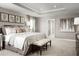 Spacious main bedroom with large bed, neutral decor, and ensuite bathroom access at 5781 Anders Way, Saint Cloud, FL 34771
