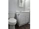 Bathroom with updated vanity and toilet, showcasing new flooring at 5840 Nw 16Th St, Ocala, FL 34482