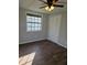 Bright bedroom with a large window, ceiling fan, and updated flooring at 5840 Nw 16Th St, Ocala, FL 34482