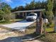 Single story home with a spacious driveway and mature trees in the yard at 5840 Nw 16Th St, Ocala, FL 34482