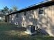 Rear view of the house showcasing a new AC unit and well-maintained yard at 5840 Nw 16Th St, Ocala, FL 34482