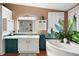 Bathroom with teal cabinets, garden theme, and bathtub at 621 Sw 79Th Ct, Ocala, FL 34474